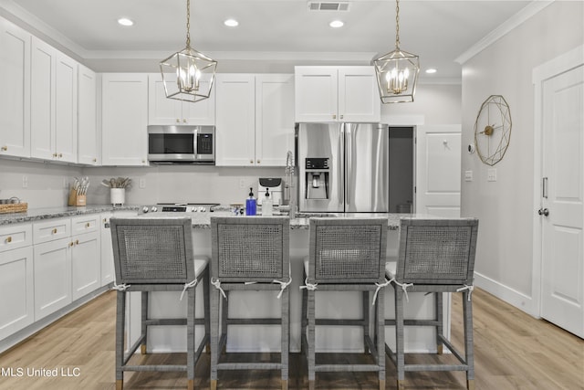 56 Oak Alley Ln, Long Beach, MS 39560 - kitchen with a chandelier, stainless steel appliances, crown molding, a center island, and white cabinets