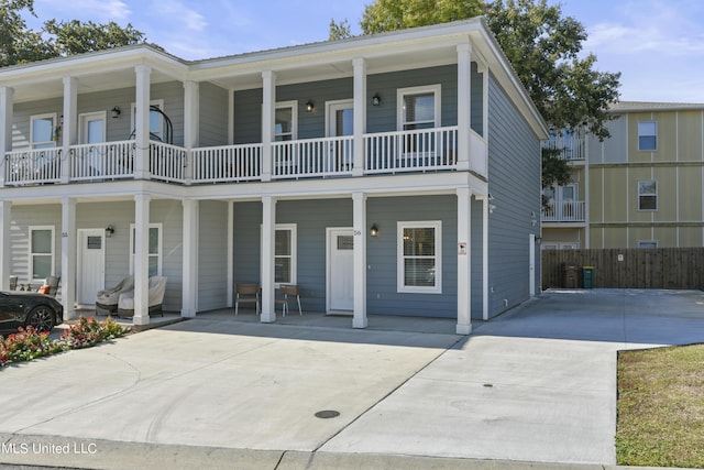 56 Oak Alley Ln, Long Beach, MS 39560 - view of front of home with a balcony, fence, and concrete driveway