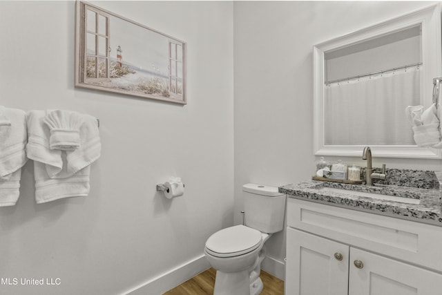 56 Oak Alley Ln, Long Beach, MS 39560 - full bathroom with wood finished floors, toilet, baseboards, and vanity