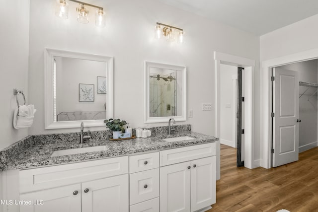 bathroom featuring vanity, hardwood / wood-style floors, and walk in shower