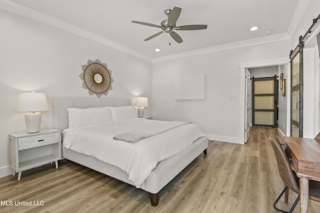 56 Oak Alley Ln, Long Beach, MS 39560 - bedroom with a barn door, light wood-style floors, baseboards, ornamental molding, and recessed lighting