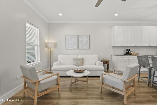 56 Oak Alley Ln, Long Beach, MS 39560 - living area with ornamental molding, baseboards, healthy amount of natural light, ceiling fan, and light wood-style flooring