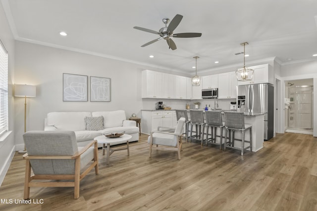 56 Oak Alley Ln, Long Beach, MS 39560 - living room featuring crown molding, ceiling fan, recessed lighting, light wood-style flooring, and baseboards