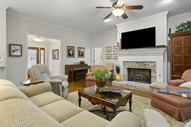 living room featuring crown molding, hardwood / wood-style floors, and a fireplace