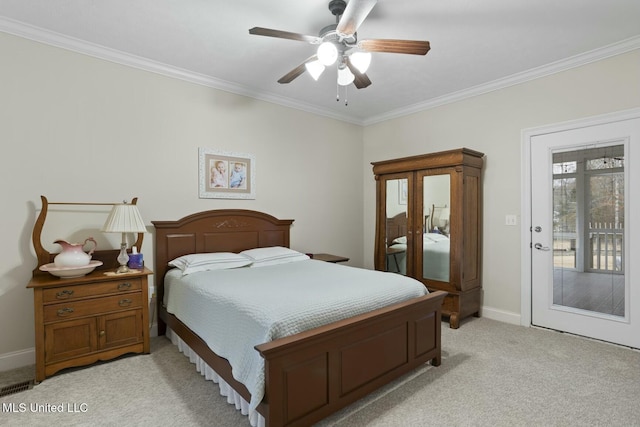 carpeted bedroom featuring ornamental molding and ceiling fan