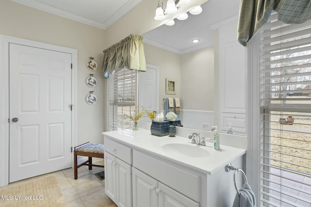 bathroom featuring tile patterned flooring, crown molding, and vanity