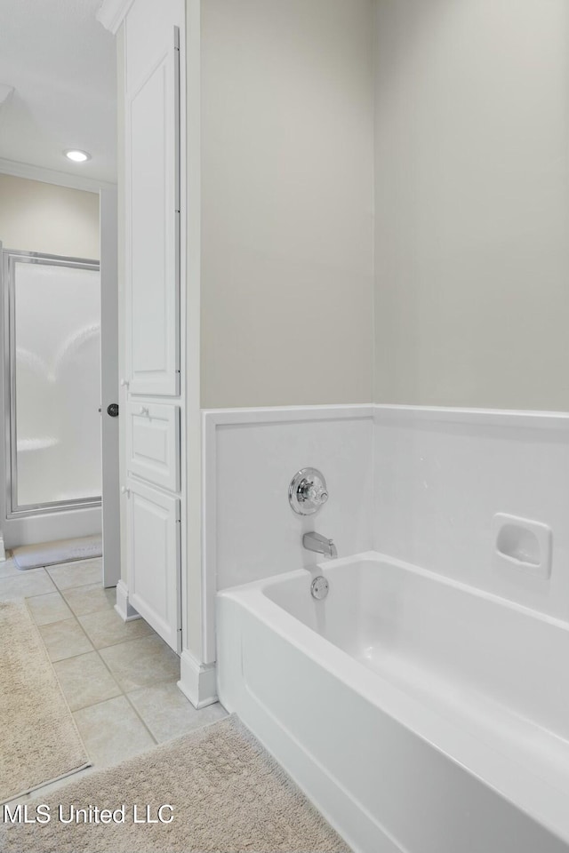 bathroom with a bath and tile patterned floors