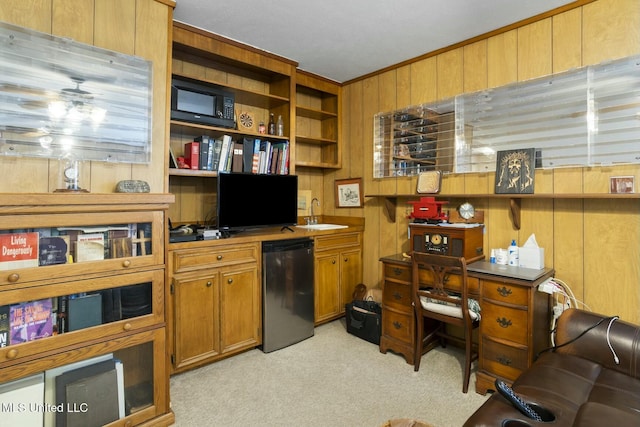 office space with crown molding, light colored carpet, and wood walls