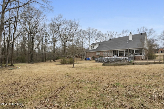 view of yard featuring a patio area and a sunroom