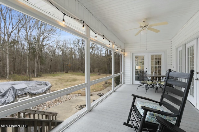 sunroom featuring ceiling fan and french doors