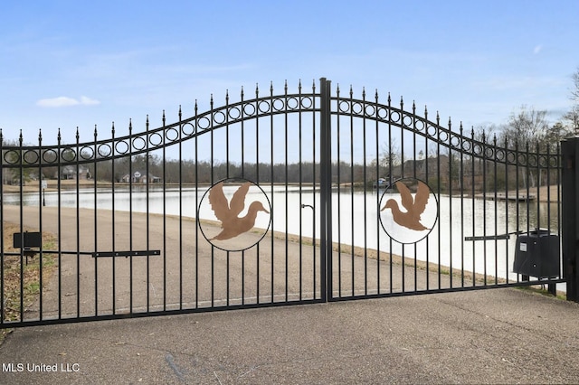 view of gate with a water view