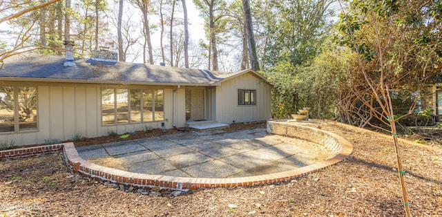 exterior space featuring roof with shingles