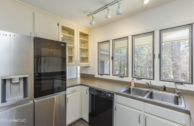 kitchen featuring a sink, white cabinetry, stainless steel fridge with ice dispenser, dishwasher, and glass insert cabinets