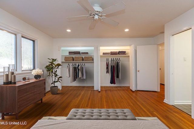 interior space featuring ceiling fan, wood finished floors, two closets, and recessed lighting