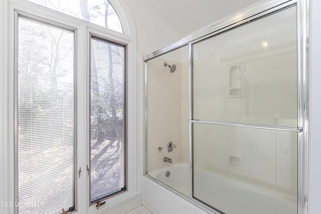 full bathroom with bath / shower combo with glass door