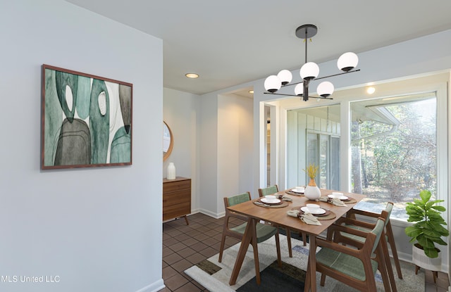 dining room with recessed lighting, dark tile patterned floors, baseboards, and an inviting chandelier