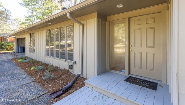 doorway to property featuring board and batten siding