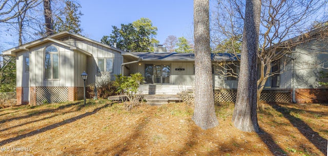 view of front of house featuring board and batten siding and a chimney