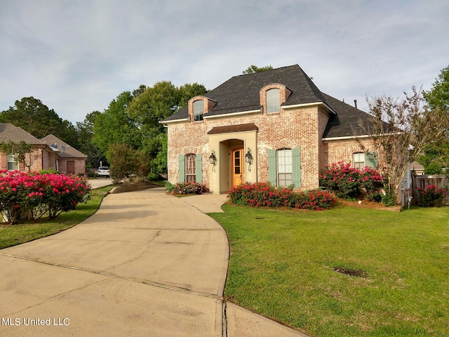 french country style house featuring a front yard