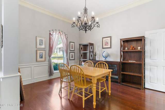 dining area with a notable chandelier, ornamental molding, and dark hardwood / wood-style floors