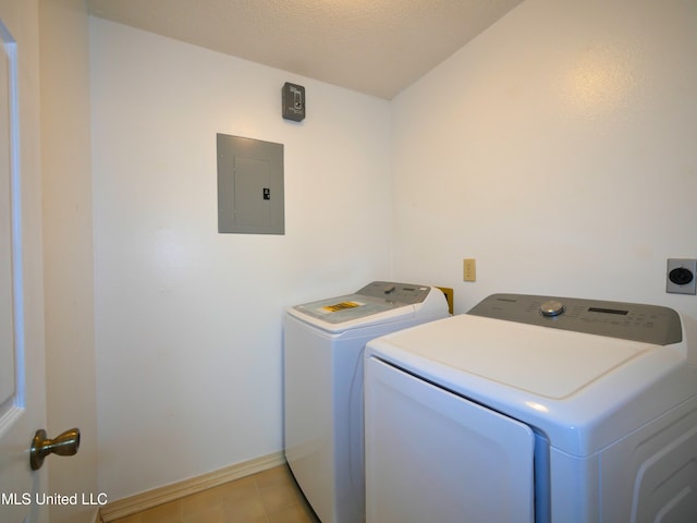 laundry area featuring washer and dryer, laundry area, electric panel, and baseboards