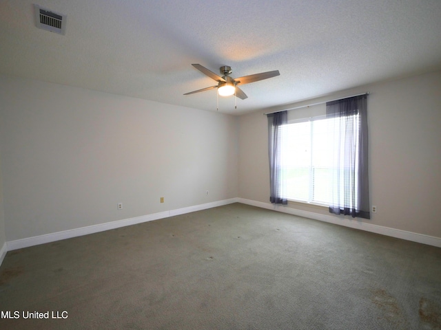 unfurnished room featuring baseboards, visible vents, carpet floors, ceiling fan, and a textured ceiling