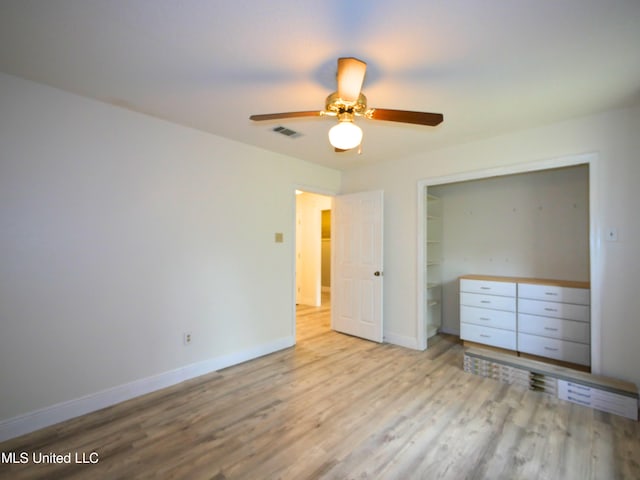 unfurnished bedroom with visible vents, baseboards, a closet, and wood finished floors