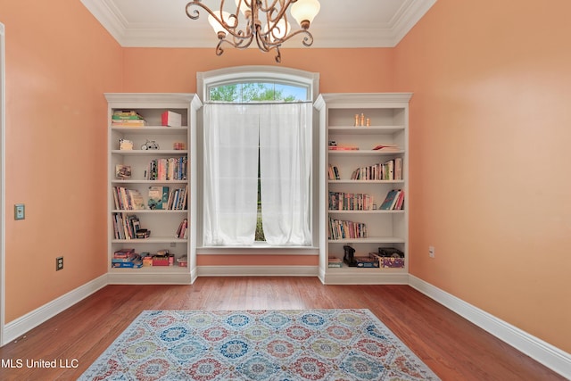 63722 N Diamondhead Dr, Diamondhead, MS 39525 - unfurnished room featuring a chandelier, crown molding, baseboards, and wood finished floors