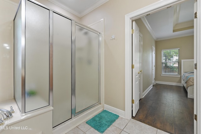 63722 N Diamondhead Dr, Diamondhead, MS 39525 - ensuite bathroom featuring crown molding, a shower stall, baseboards, and tile patterned floors