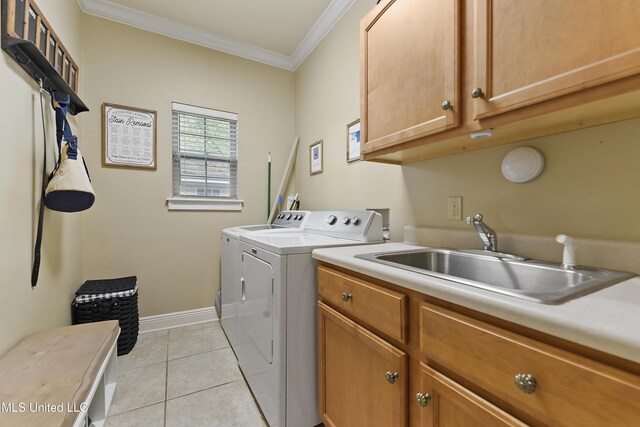 63722 N Diamondhead Dr, Diamondhead, MS 39525 - laundry area with cabinet space, washing machine and clothes dryer, crown molding, baseboards, and light tile patterned floors