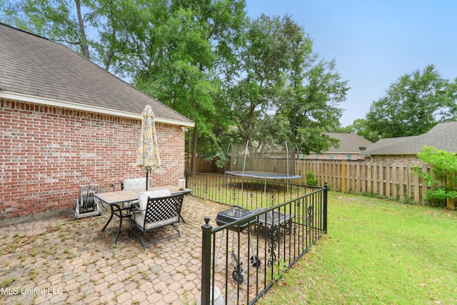 63722 N Diamondhead Dr, Diamondhead, MS 39525 - view of yard featuring a trampoline, a patio area, and outdoor dining area