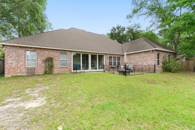 63722 N Diamondhead Dr, Diamondhead, MS 39525 - rear view of house featuring brick siding, roof with shingles, and a patio area