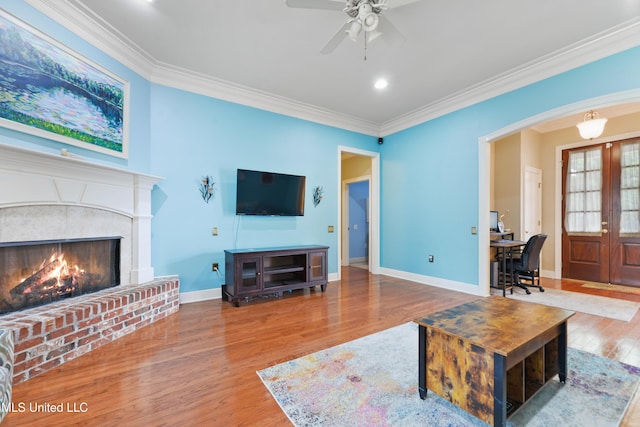 63722 N Diamondhead Dr, Diamondhead, MS 39525 - living area featuring wood finished floors, an office area, a ceiling fan, ornamental molding, and a fireplace