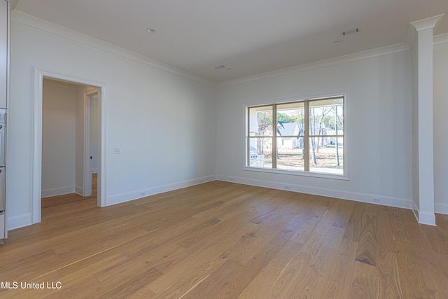 spare room with crown molding and light hardwood / wood-style floors