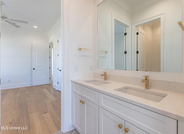 bathroom with ceiling fan, vanity, and hardwood / wood-style floors