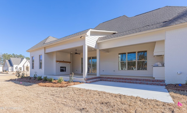 rear view of property featuring a patio area and ceiling fan