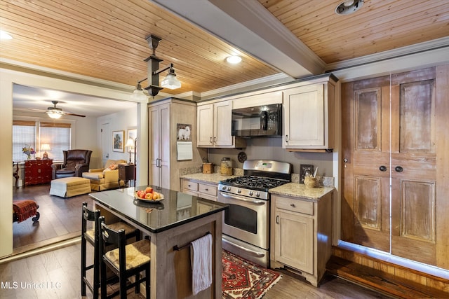 kitchen with black microwave, stainless steel gas range oven, wood ceiling, hardwood / wood-style floors, and crown molding