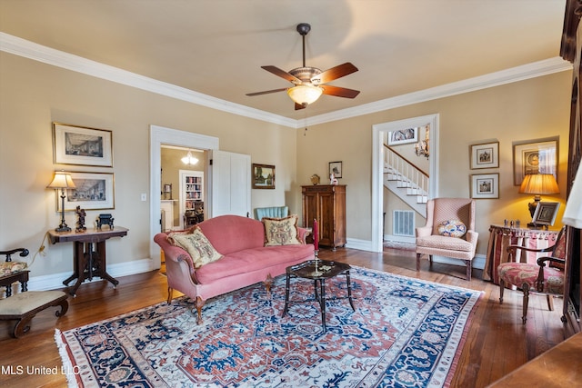 living area featuring visible vents, ornamental molding, hardwood / wood-style flooring, and baseboards