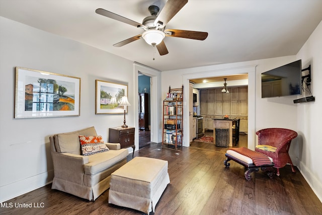 sitting room featuring ceiling fan, dark wood-style flooring, and baseboards