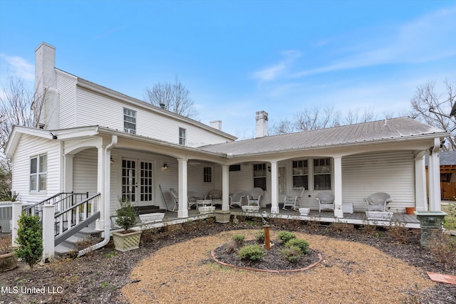 view of front facade featuring metal roof, french doors, and a porch