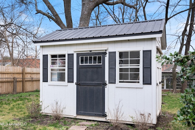 view of shed with fence