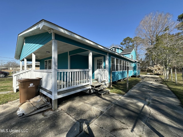 view of property exterior featuring covered porch