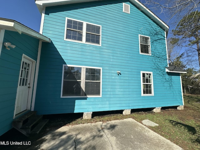 view of side of home with entry steps