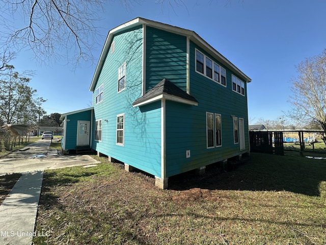 view of home's exterior with a lawn