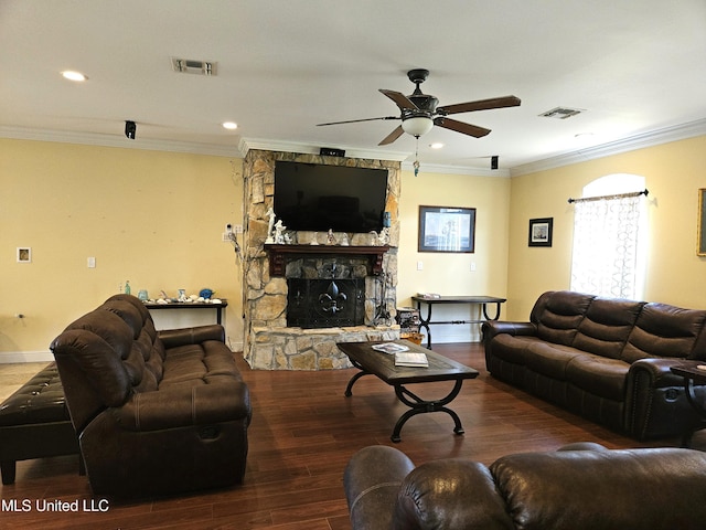 living room with a stone fireplace, crown molding, hardwood / wood-style flooring, and ceiling fan