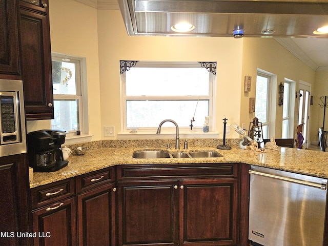 kitchen featuring appliances with stainless steel finishes, crown molding, a healthy amount of sunlight, and sink