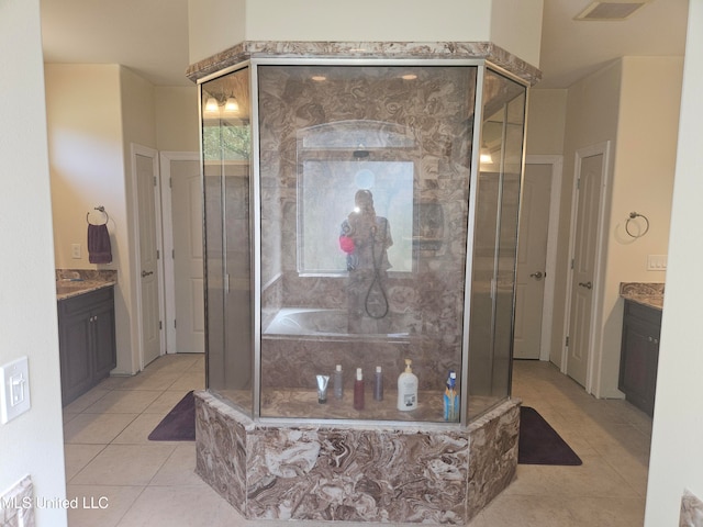 bathroom with vanity, a shower with shower door, and tile patterned flooring