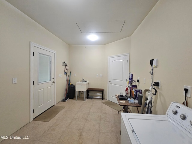 clothes washing area featuring washer / dryer and sink