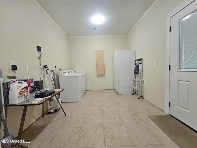 washroom with washing machine and clothes dryer