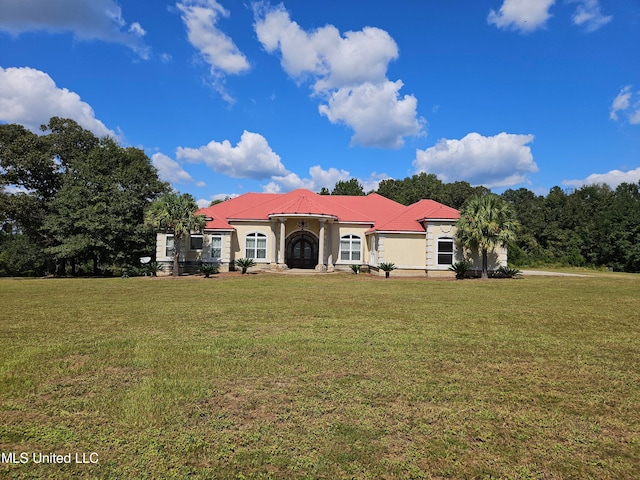 back of property with a lawn